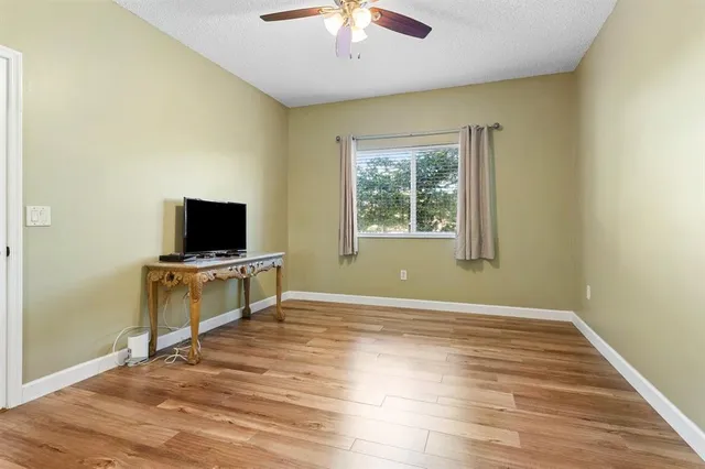 a view of a livingroom with wooden floor and a flat screen tv