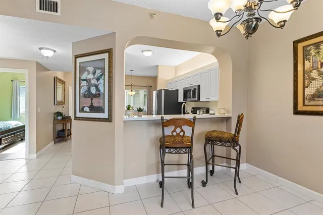 a view of a dining room with furniture and a chandelier