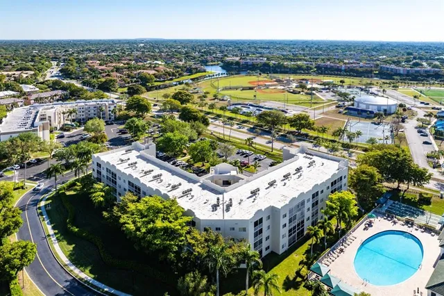 an aerial view of residential houses with outdoor space and swimming pool