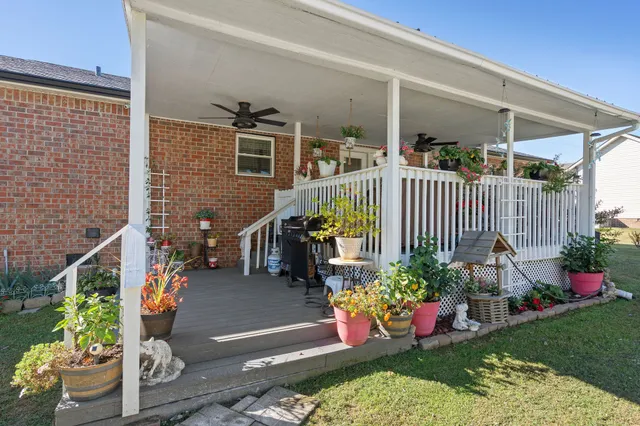a view of a porch with furniture and plants
