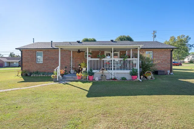a front view of a house with a garden and porch