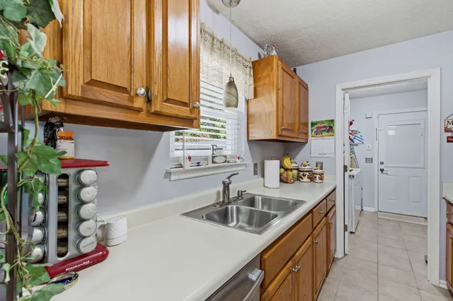 a kitchen with stainless steel appliances a sink a stove and a wooden cabinets