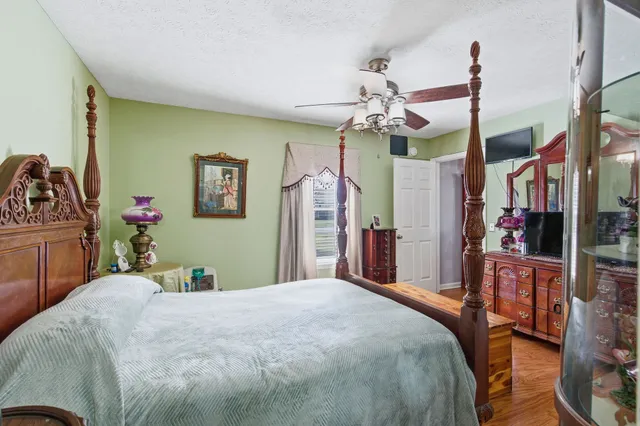 a bedroom with a bed and a chandelier