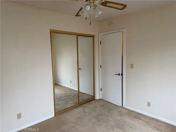 an empty room with a ceiling fan