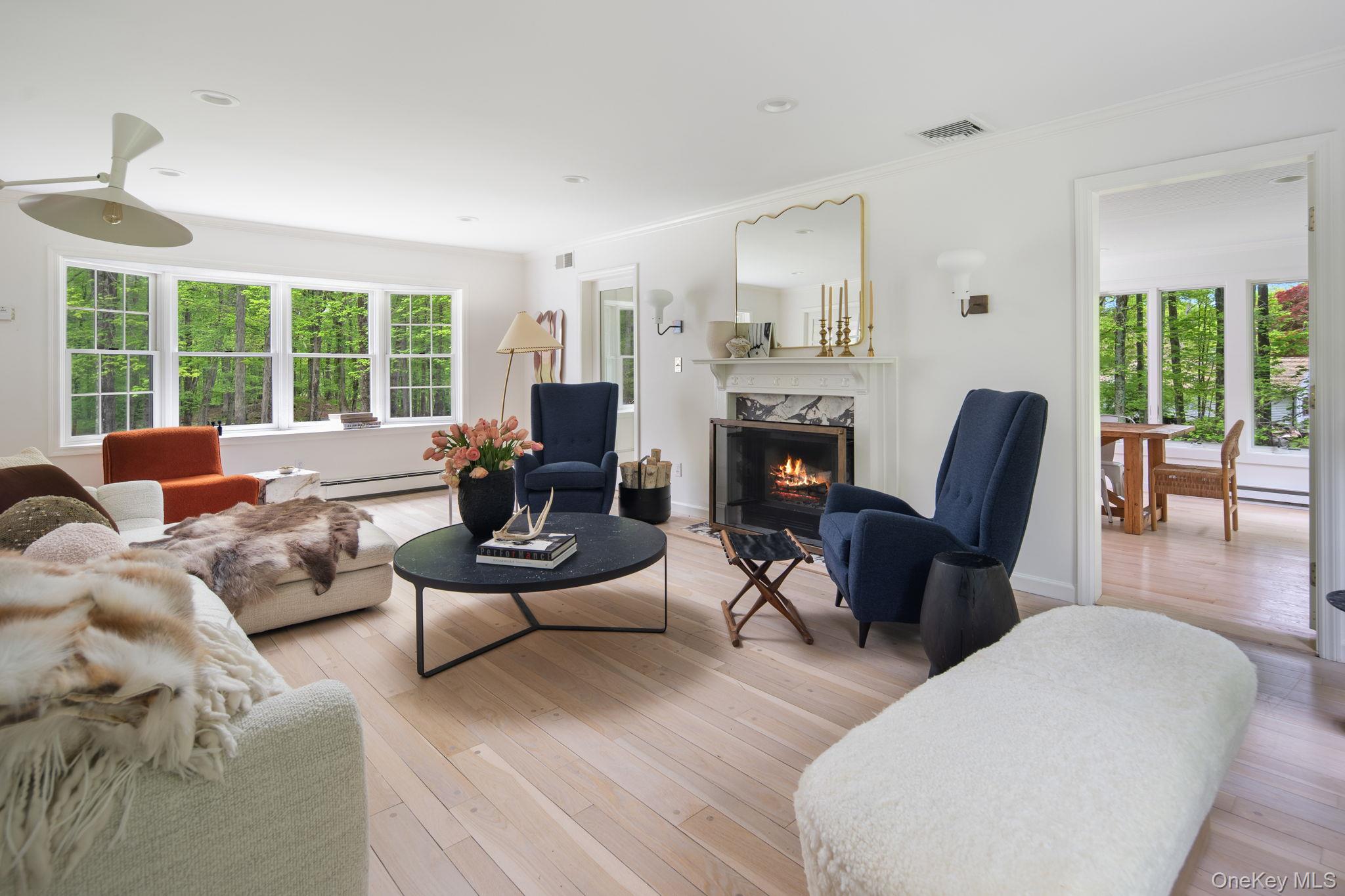 240 Eastwoods Road Pound Ridge, NY 10576 - Photo 5 of 13 a living room with furniture fireplace and a large window