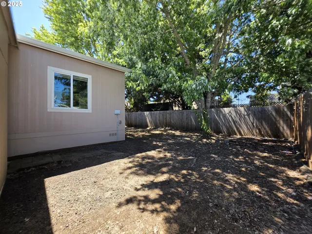 a view of a yard with a tree