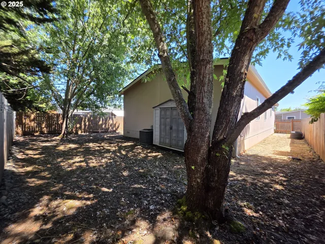a view of a pathway gate with wooden fence