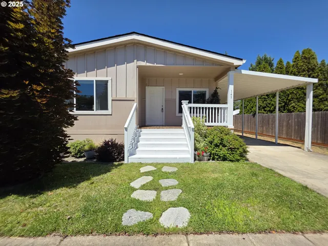 a front view of a house with cars parked