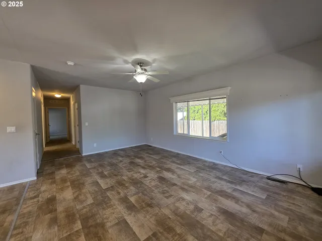a view of an empty room with a kitchen