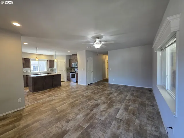 a view of kitchen and hall with wooden floor