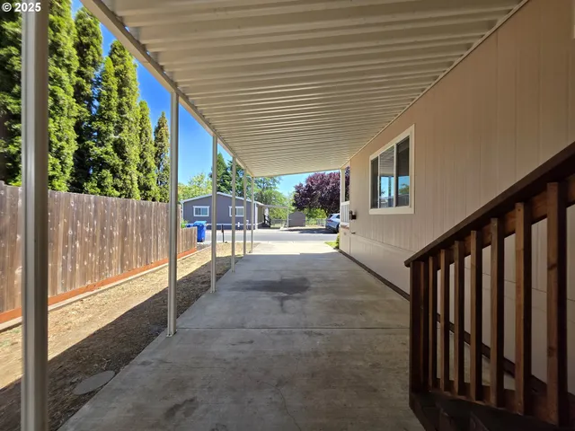 a view of a backyard with wooden fence