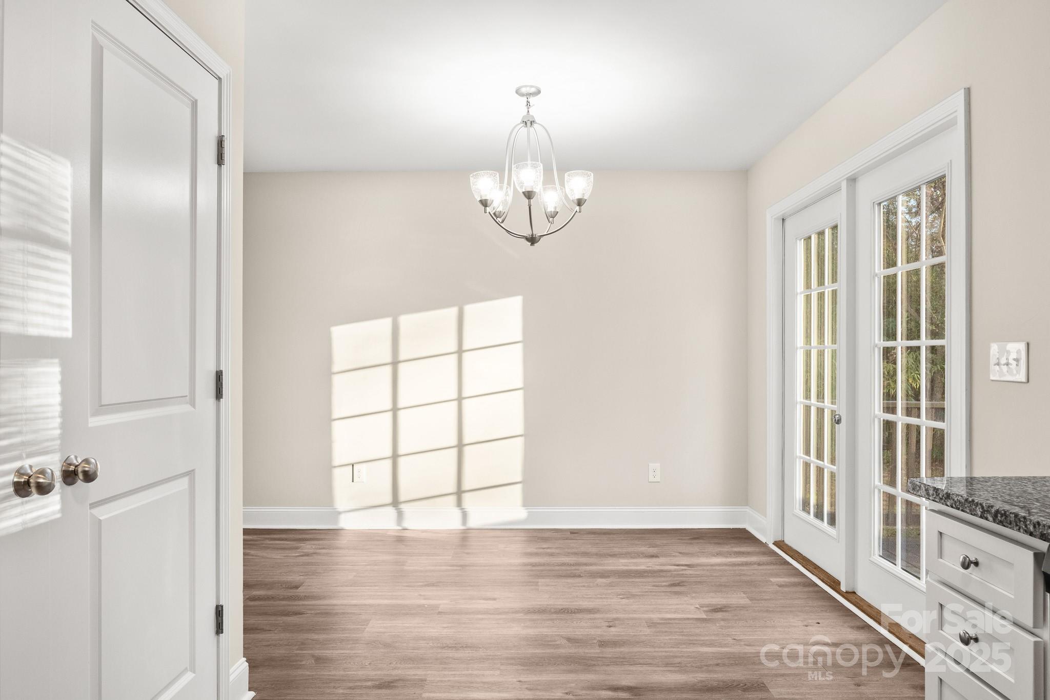 1219 Calhoun Street Rock Hill, SC 29732 - Photo 13 of 33 a view of an empty room with a window and wooden floor