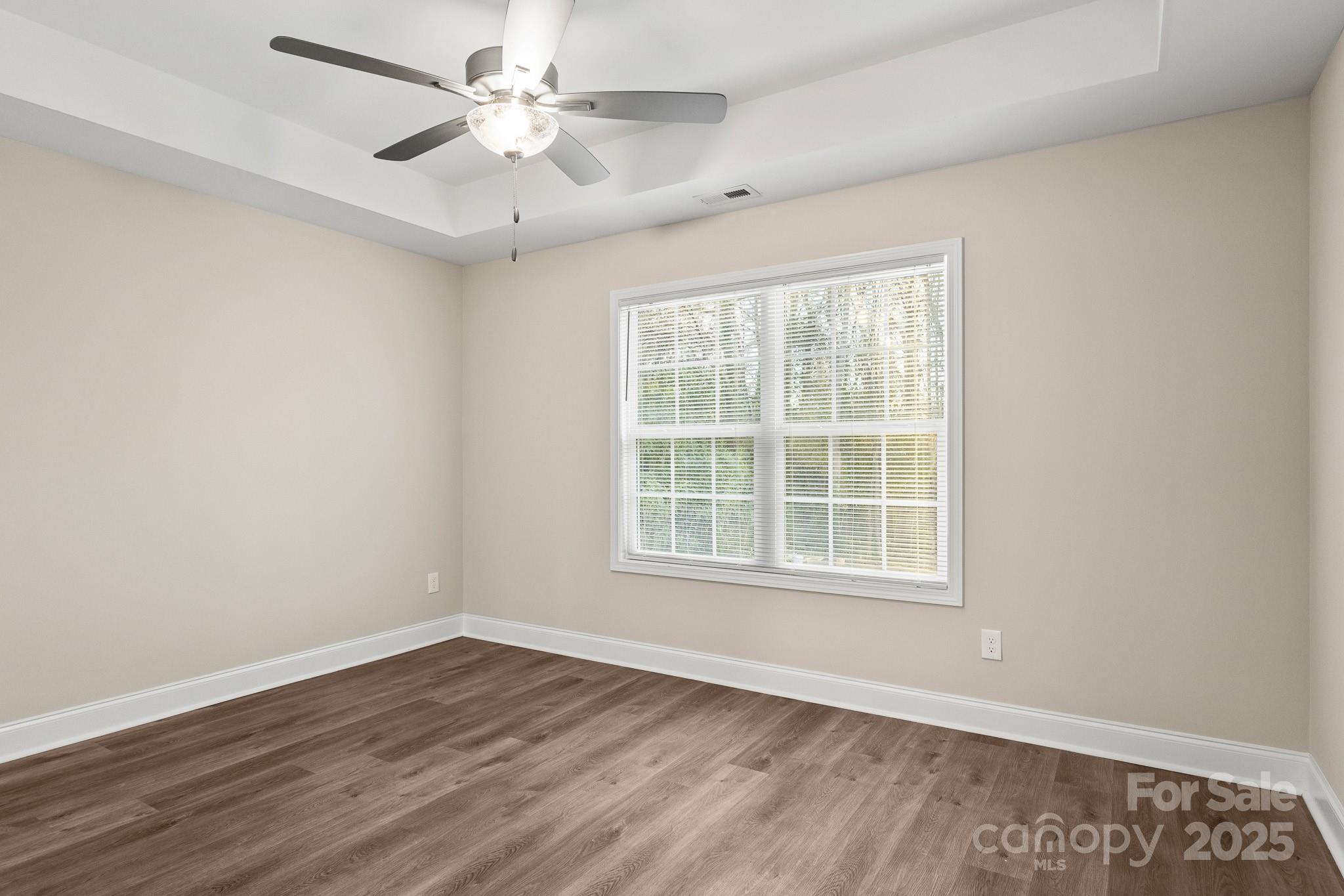 1219 Calhoun Street Rock Hill, SC 29732 - Photo 14 of 33 an empty room with wooden floor and windows