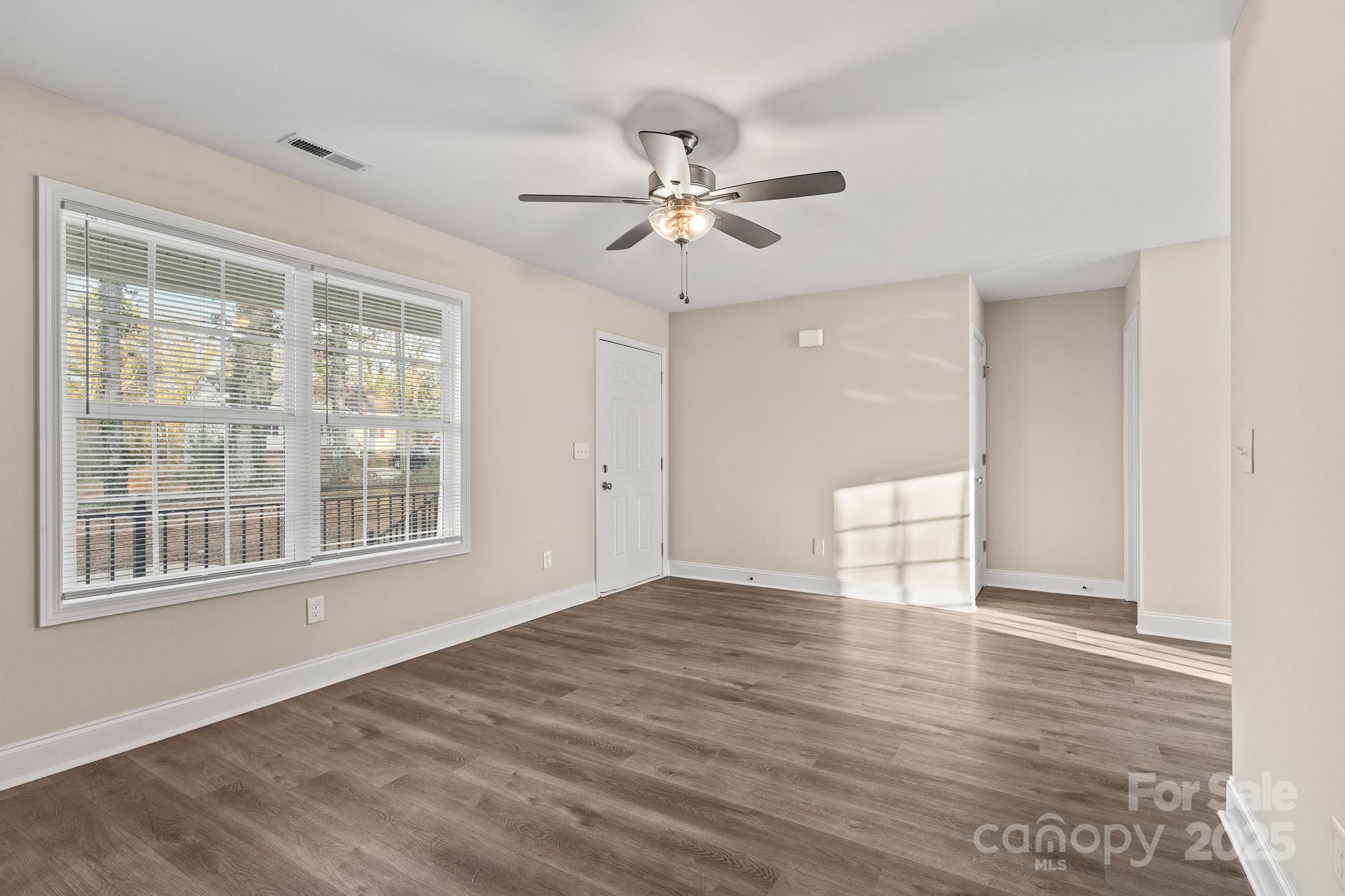 1219 Calhoun Street Rock Hill, SC 29732 - Photo 2 of 33 a view of an empty room with a window and wooden floor
