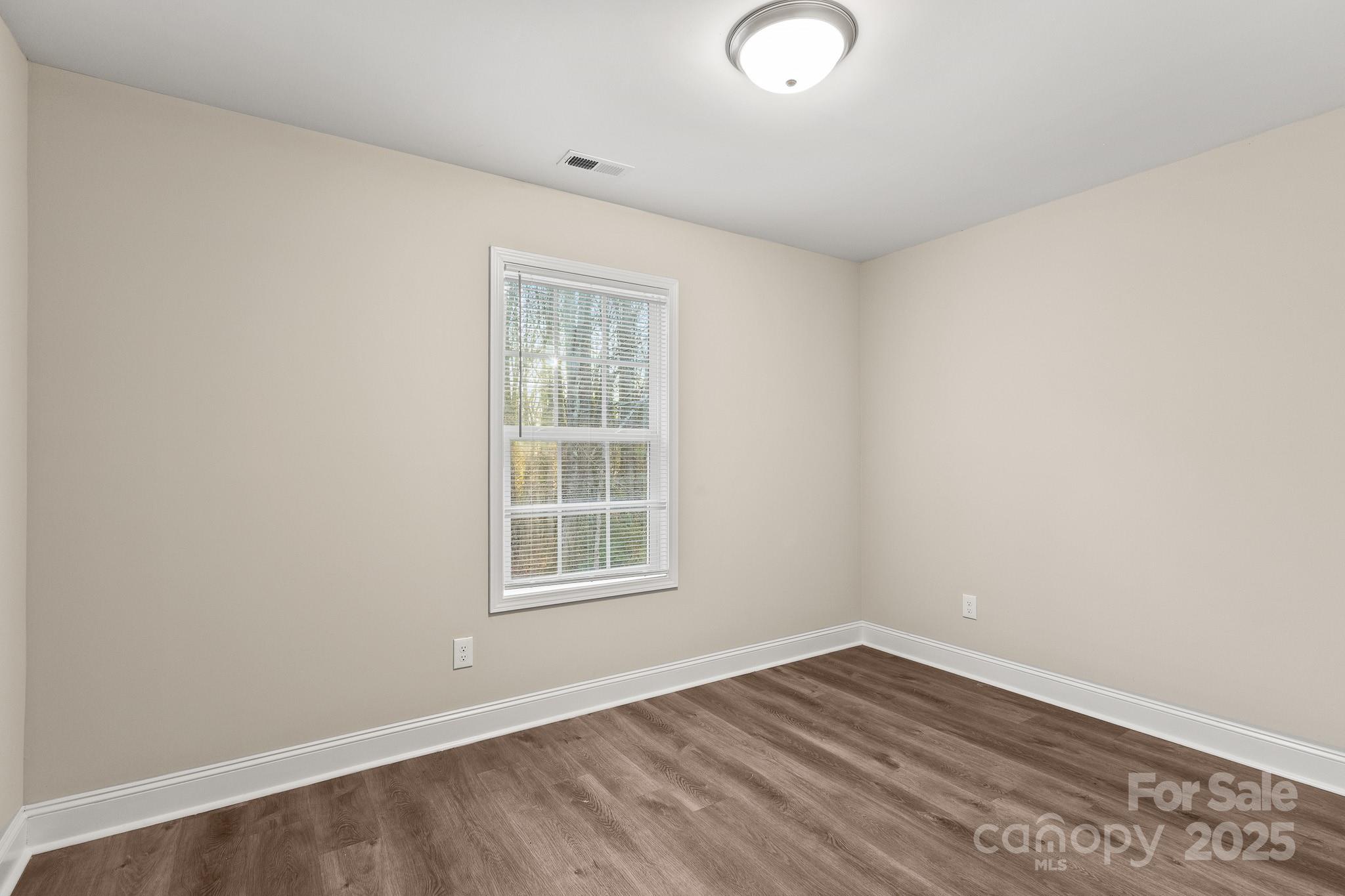 1219 Calhoun Street Rock Hill, SC 29732 - Photo 21 of 33 an empty room with wooden floor and windows