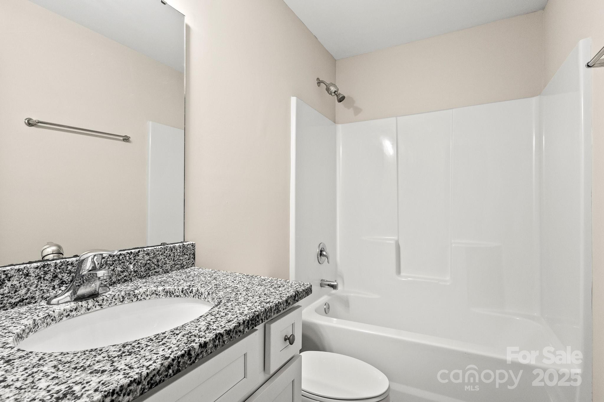 1219 Calhoun Street Rock Hill, SC 29732 - Photo 26 of 33 a bathroom with a granite countertop sink and a mirror