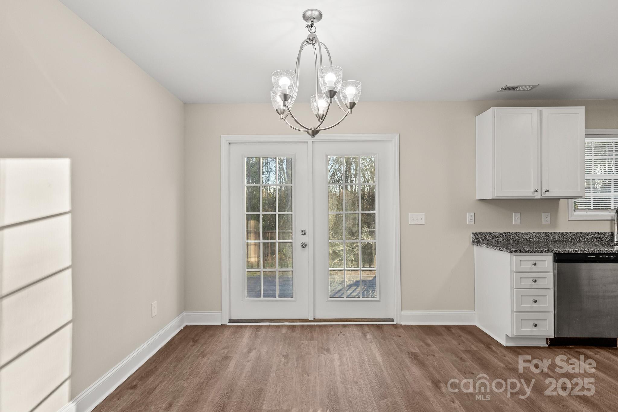 1219 Calhoun Street Rock Hill, SC 29732 - Photo 7 of 33 a view of an empty room with wooden floor and a window