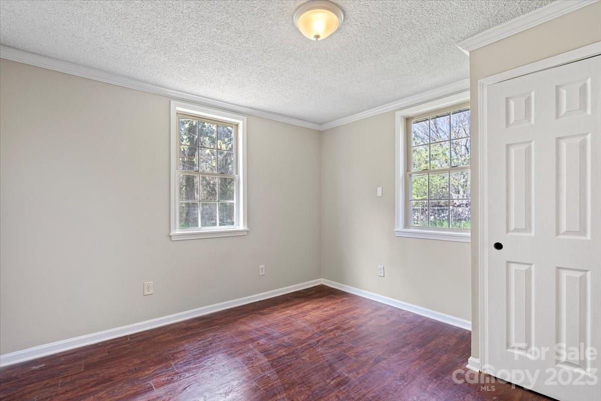 750 Lakeview Road Salisbury, NC 28147 - Photo 12 of 22 an empty room with wooden floor and windows