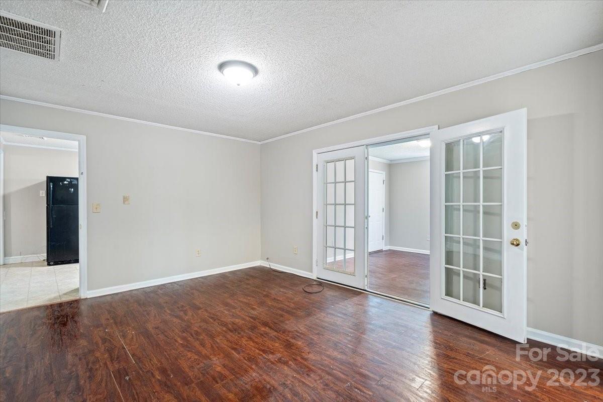 750 Lakeview Road Salisbury, NC 28147 - Photo 13 of 22 a view of an empty room with wooden floor and a window