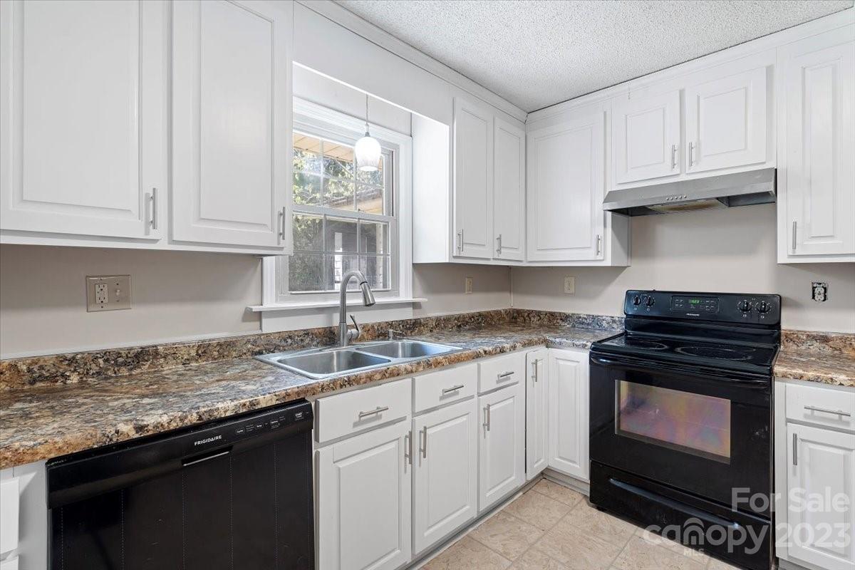 750 Lakeview Road Salisbury, NC 28147 - Photo 18 of 22 a kitchen with granite countertop a stove sink and cabinets