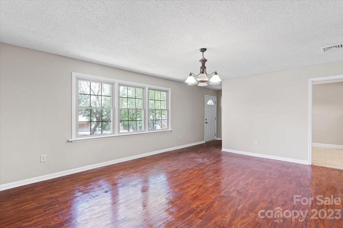 750 Lakeview Road Salisbury, NC 28147 - Photo 5 of 22 a view of an empty room with wooden floor and a window