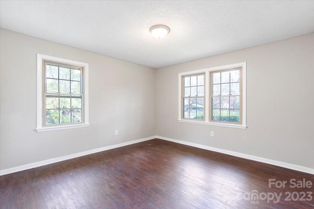 750 Lakeview Road Salisbury, NC 28147 - Photo 7 of 22 an empty room with wooden floor and windows
