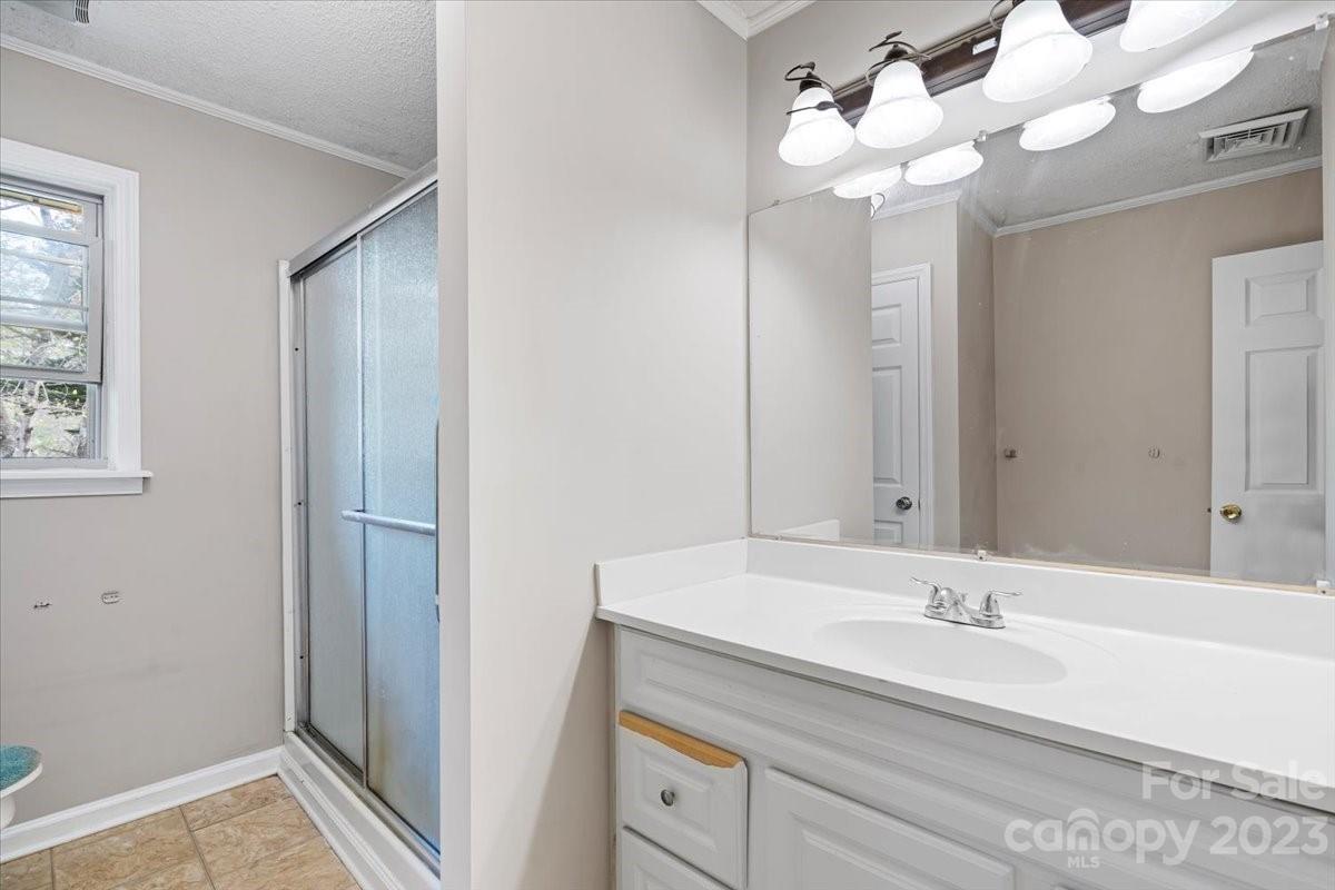 750 Lakeview Road Salisbury, NC 28147 - Photo 9 of 22 a bathroom with a sink a mirror and a light fixture