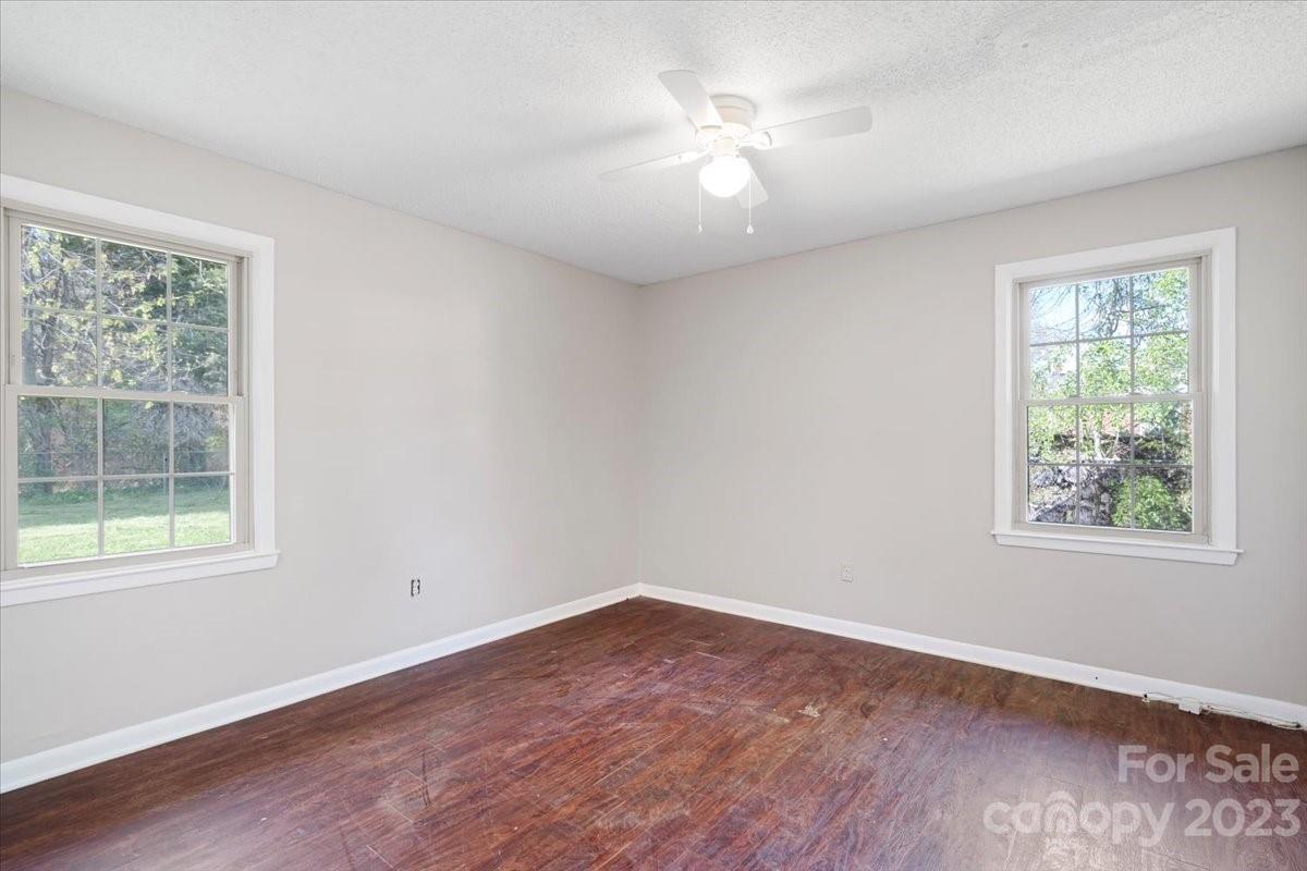 750 Lakeview Road Salisbury, NC 28147 - Photo 10 of 22 an empty room with wooden floor and windows