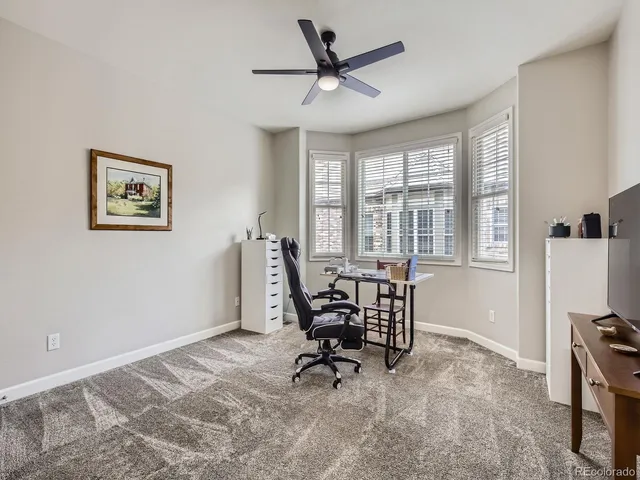 a workspace room with furniture and windows