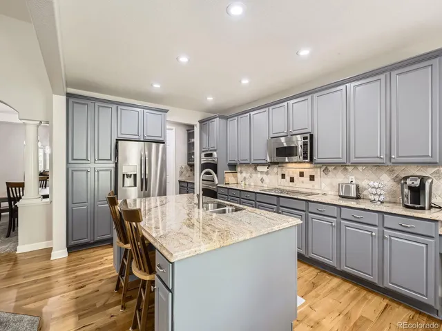 a kitchen with refrigerator cabinets dining table and chairs