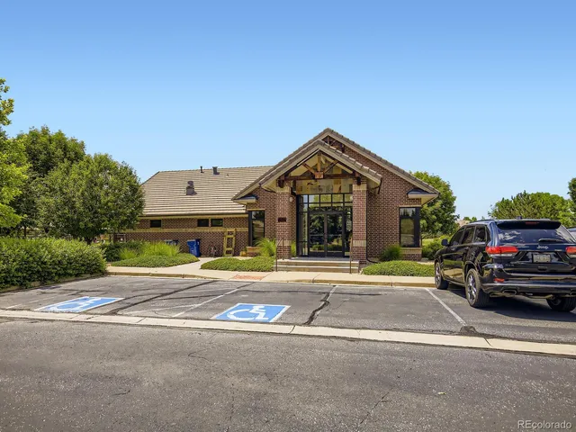 a view of a lake with lawn chairs and a big yard