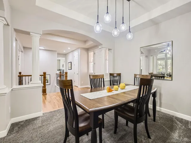 a view of a dining area with furniture and a chandelier