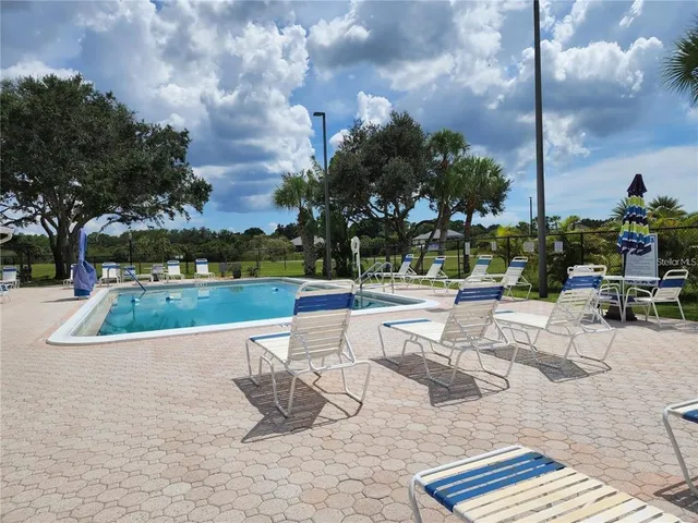 a view of swimming pool with seating space