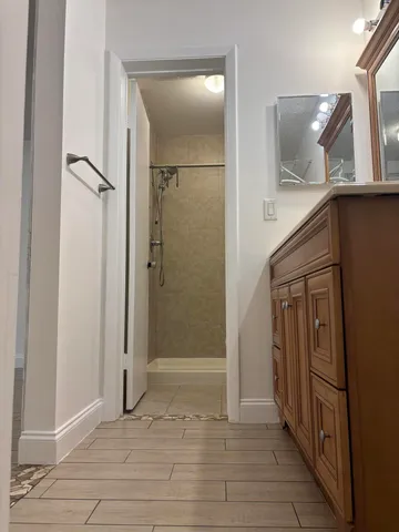 a view of a hallway with wooden floor