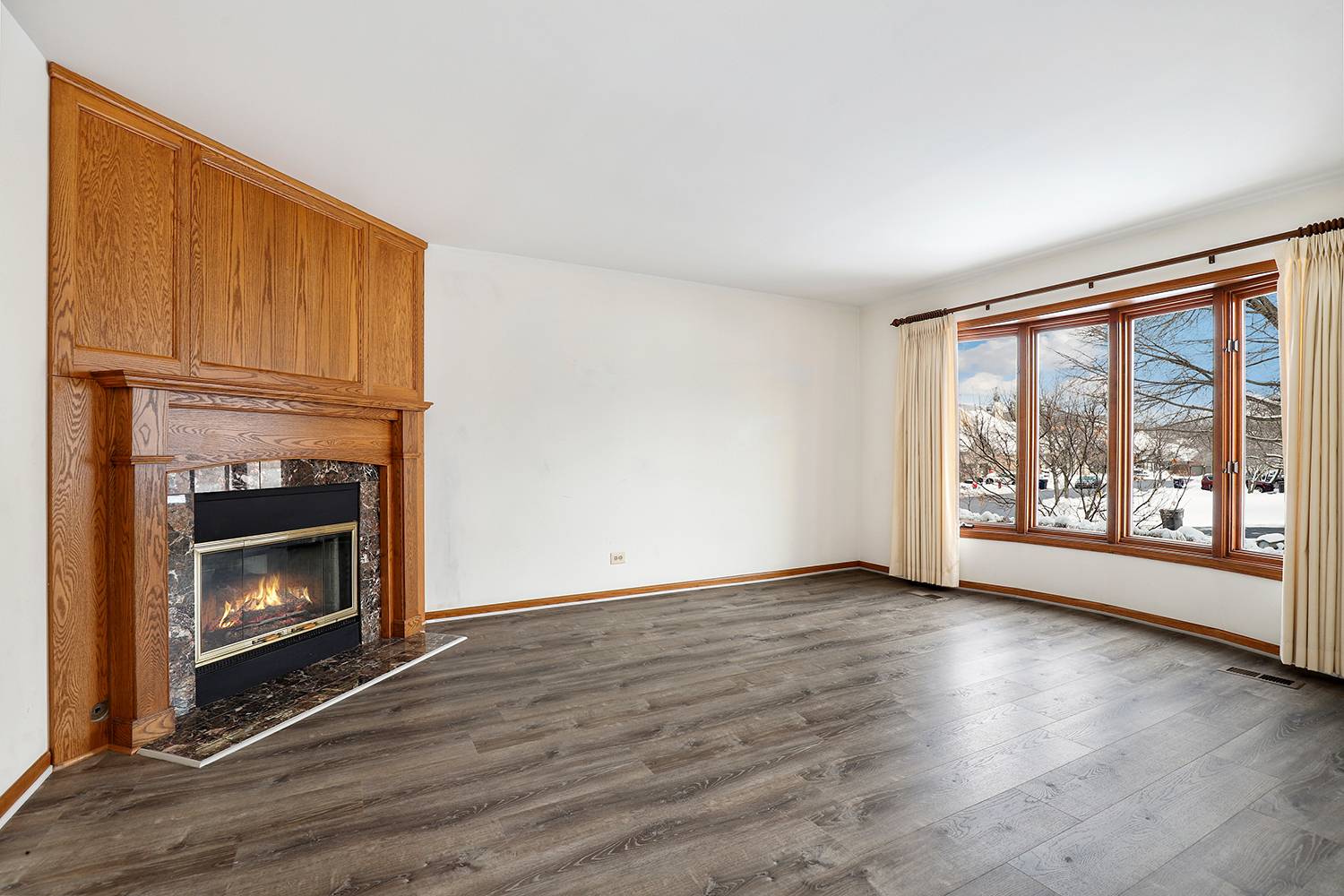 14518 Golf Road Orland Park, IL 60462 - Photo 3 of 42 a view of an empty room with wooden floor fireplace and a window