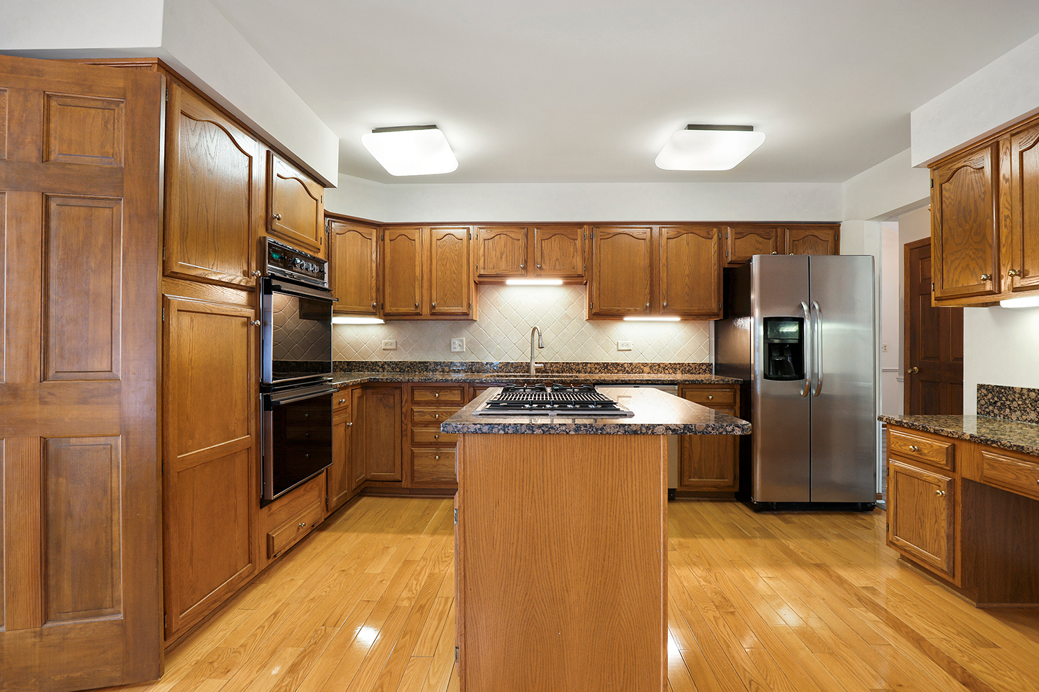 14518 Golf Road Orland Park, IL 60462 - Photo 6 of 42 a kitchen with granite countertop stainless steel appliances a refrigerator stove top oven and sink