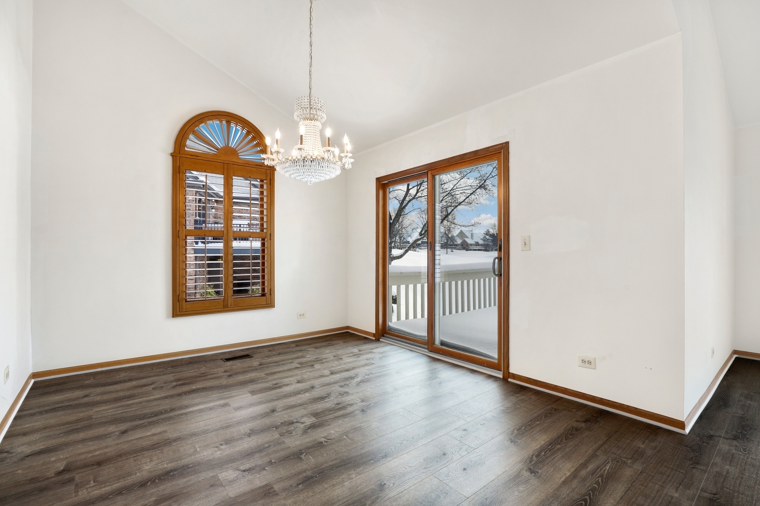 14518 Golf Road Orland Park, IL 60462 - Photo 9 of 42 an empty room with wooden floor chandelier and windows