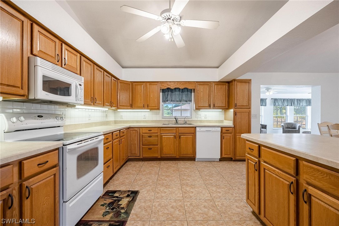7764 14th Place LaBelle, FL 33935 - Photo 14 of 34 a kitchen with stainless steel appliances granite countertop a sink and cabinets