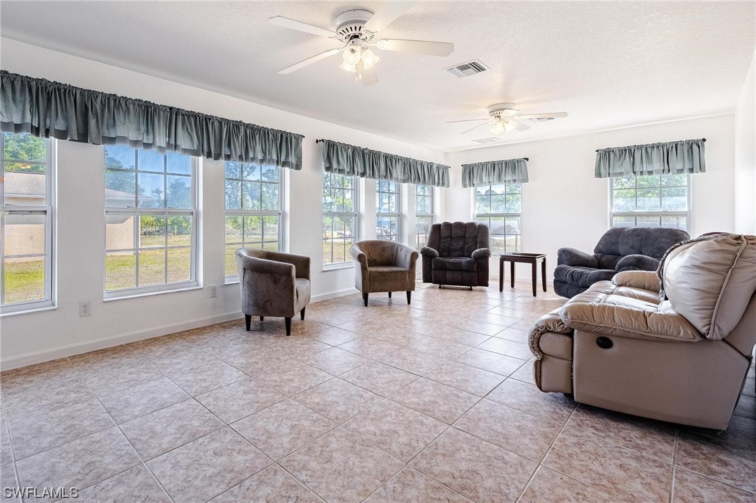 7764 14th Place LaBelle, FL 33935 - Photo 17 of 34 a living room with furniture and large windows