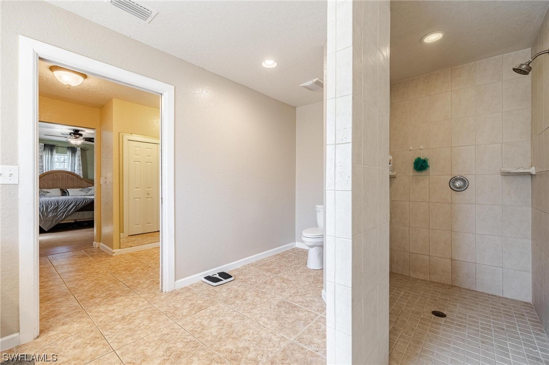 7764 14th Place LaBelle, FL 33935 - Photo 21 of 34 a view of a bathroom with a glass door shower