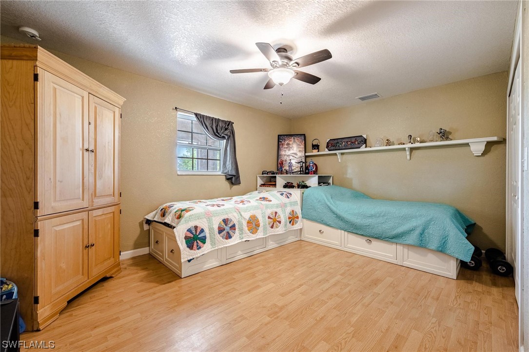 7764 14th Place LaBelle, FL 33935 - Photo 23 of 34 a bed sitting in a bedroom next to a window