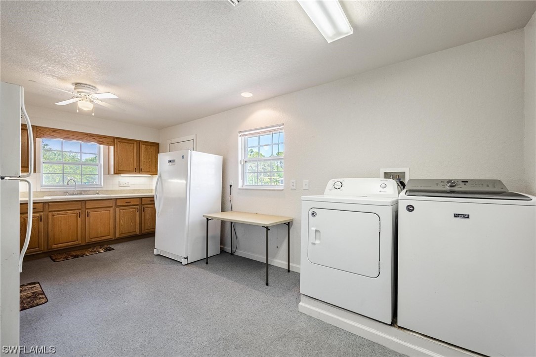 7764 14th Place LaBelle, FL 33935 - Photo 27 of 34 a utility room with dryer and washer