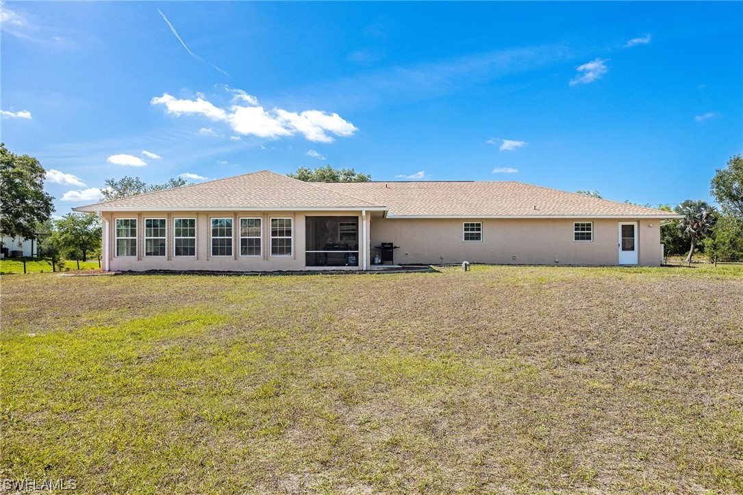 7764 14th Place LaBelle, FL 33935 - Photo 31 of 34 a view of a house with a swimming pool