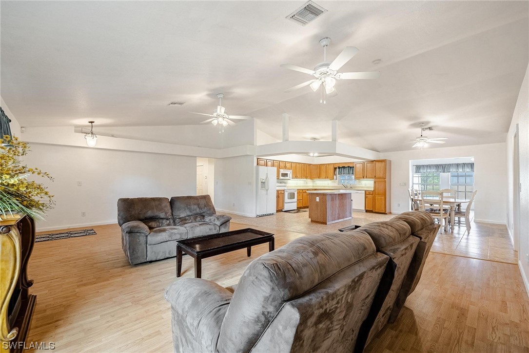7764 14th Place LaBelle, FL 33935 - Photo 5 of 34 a living room with furniture a large window and wooden floor