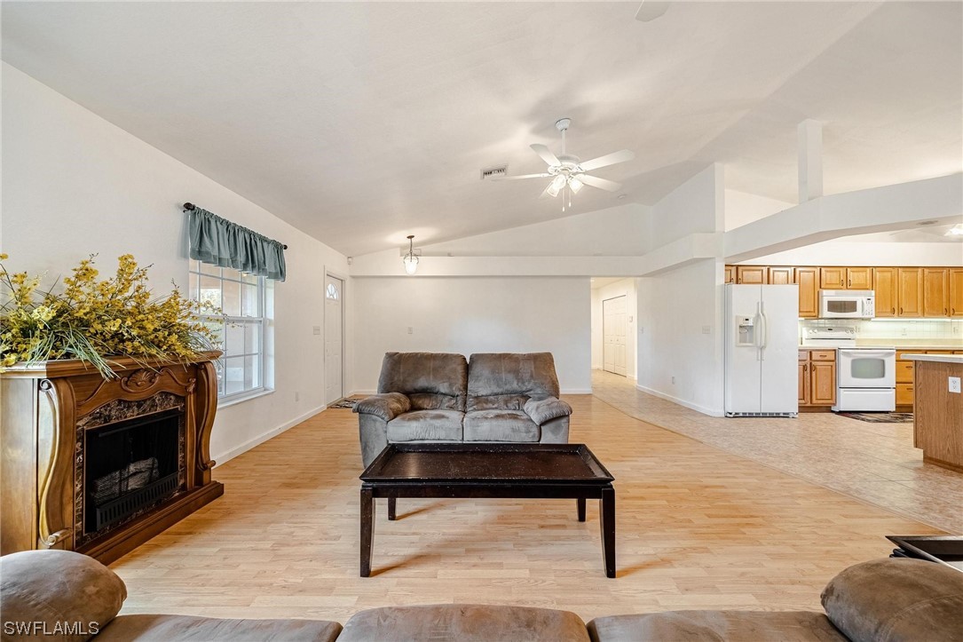 7764 14th Place LaBelle, FL 33935 - Photo 7 of 34 a living room with furniture a fireplace and a flat screen tv