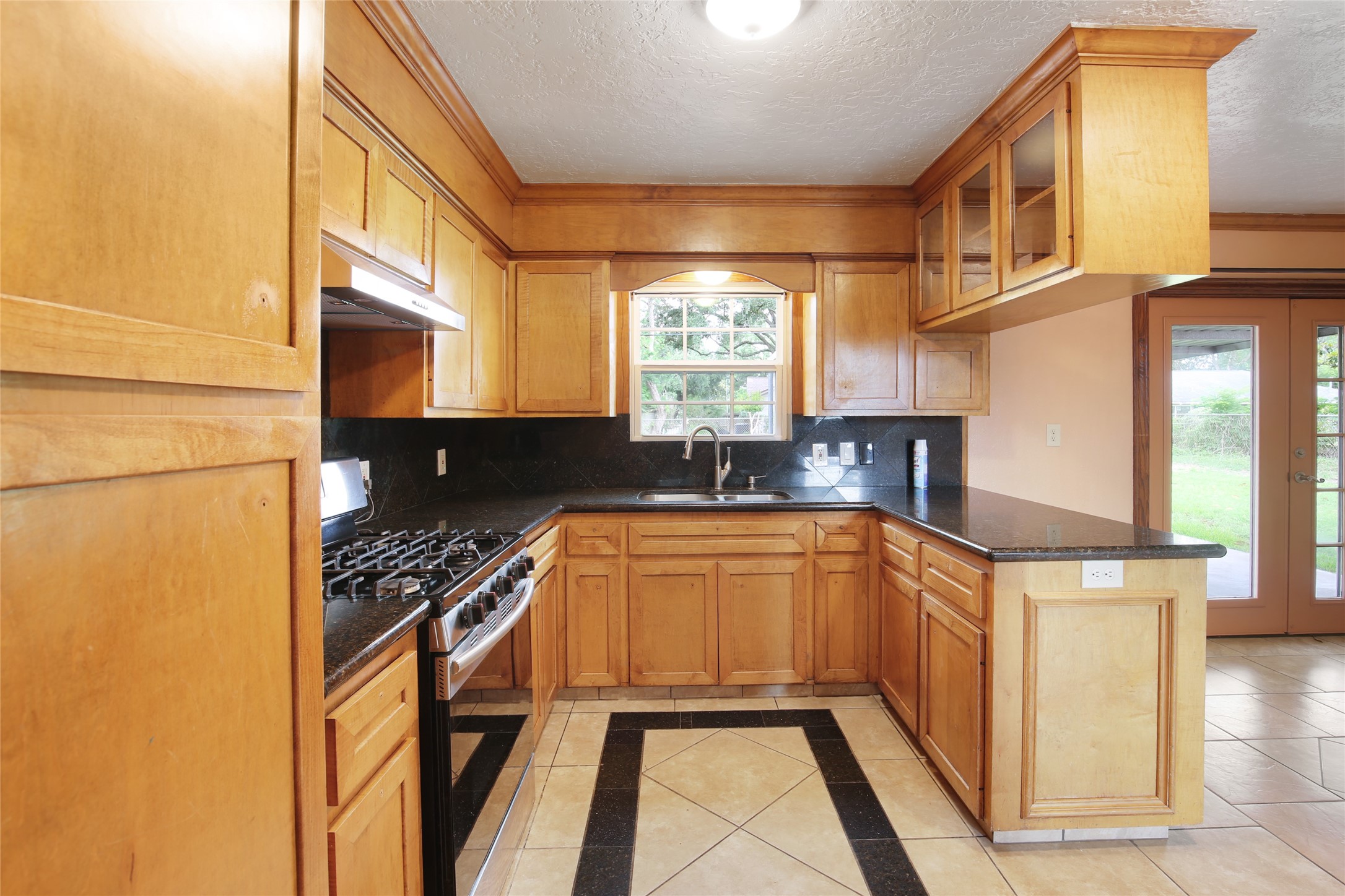 6923 Leader Street Houston, TX 77074 - Photo 10 of 19 a kitchen with stainless steel appliances granite countertop a stove and a refrigerator
