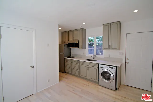 a kitchen with a stove top oven and sink