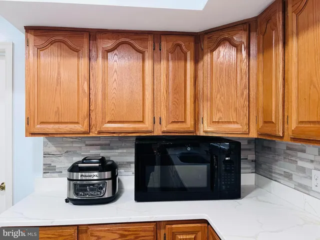 a kitchen with wooden cabinets and a refrigerator