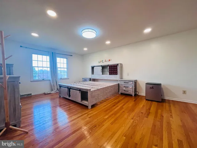 a large white room with a bed and a couch