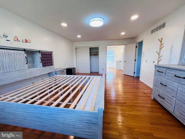 a view of room with hardwood flooring and ceiling fan